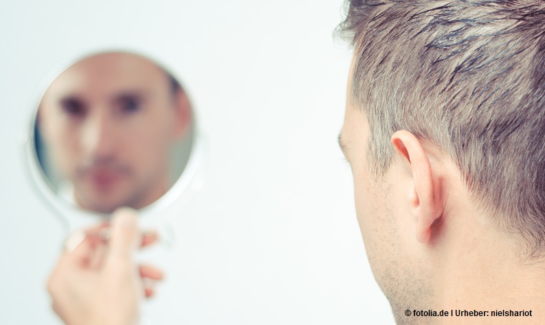 ego man reflection in mirror on a white background
