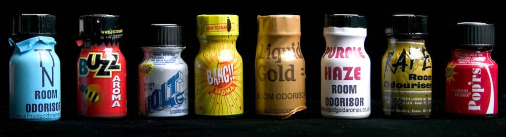 Various poppers bottles with colourful labels, as used as intoxicants during sex