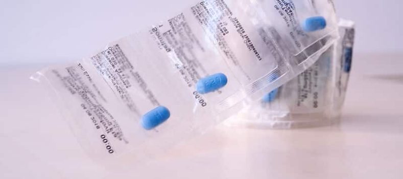 Several medication blister packs on a table - symbolic image for PrEP as part of safer sex.