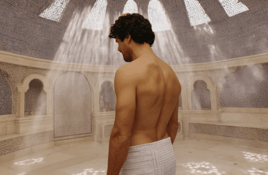 Young man wearing only a towel in a steaming Syrian hamam