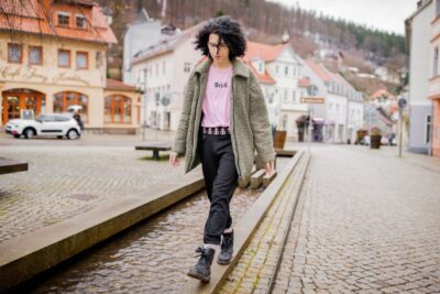 Lizzy walks confidently through a small town