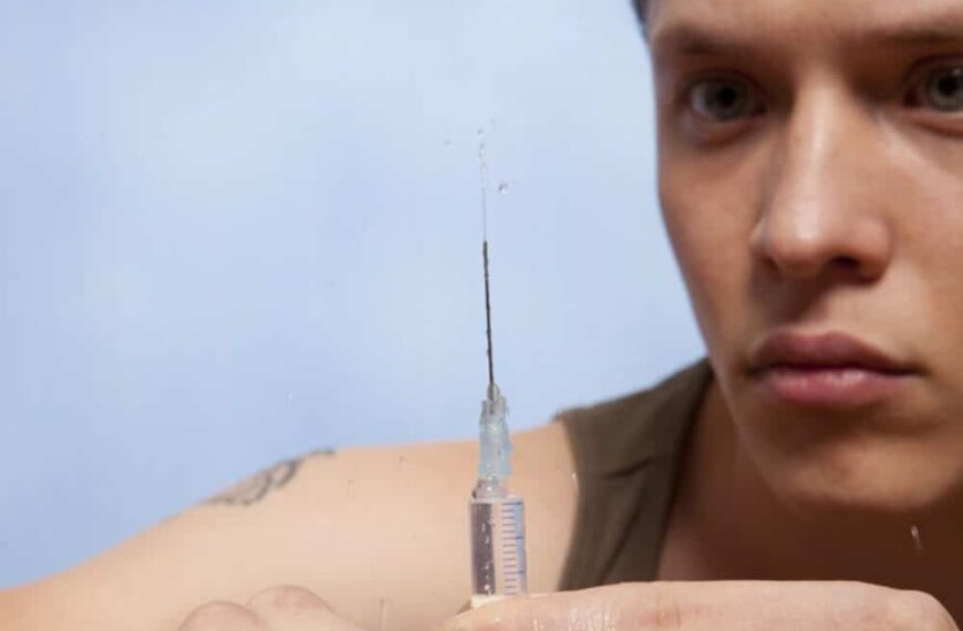 Young man with syringe - symbolic image for slamming and drug use among gay men